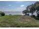Expansive lot overlooking a lake, featuring a lush lawn and mature trees, providing a serene backdrop at 184 Melissa Trl, Auburndale, FL 33823