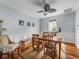 Bright dining room featuring a wooden table, bench, and chairs, complemented by modern lighting at 184 Melissa Trl, Auburndale, FL 33823
