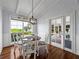 Bright dining area boasts beautiful wood floors, bright white walls, and view of the backyard at 184 Melissa Trl, Auburndale, FL 33823
