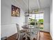 Dining area boasts beautiful wood floors, bright white walls, and view of the backyard at 184 Melissa Trl, Auburndale, FL 33823