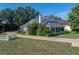 Beautiful home showcasing a long brick driveway, lush landscaping, and a well-manicured lawn at 184 Melissa Trl, Auburndale, FL 33823