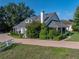 This home boasts a brick driveway, mature trees, and a cozy porch, all enhancing its curb appeal at 184 Melissa Trl, Auburndale, FL 33823