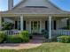 Inviting front porch featuring a cozy swing and verdant foliage at 184 Melissa Trl, Auburndale, FL 33823