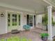 Charming front porch featuring a cozy swing and verdant foliage at 184 Melissa Trl, Auburndale, FL 33823