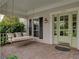 Charming front porch featuring a cozy swing and verdant foliage at 184 Melissa Trl, Auburndale, FL 33823