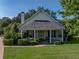 Charming home featuring a quaint front porch with classic columns and lush landscaping at 184 Melissa Trl, Auburndale, FL 33823
