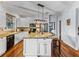 Bright kitchen with island, granite countertops, stainless appliances and white cabinetry at 184 Melissa Trl, Auburndale, FL 33823