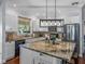 Bright kitchen with island and granite countertops, as well as stainless steel appliances at 184 Melissa Trl, Auburndale, FL 33823