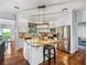 Open-concept kitchen with stainless steel appliances, granite countertops, and center island seating at 184 Melissa Trl, Auburndale, FL 33823