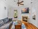 Inviting living room features a fireplace, ceiling fan and an abundance of natural light at 184 Melissa Trl, Auburndale, FL 33823