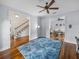 Spacious living room with hardwood floors, a large rug, and views to the dining and stairwell at 184 Melissa Trl, Auburndale, FL 33823