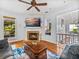 Cozy living room features a fireplace, ceiling fan and access to outdoor space at 184 Melissa Trl, Auburndale, FL 33823