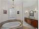 The main bathroom features a soaking tub, granite countertops, and tiled floors at 184 Melissa Trl, Auburndale, FL 33823