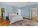 A third view of the main bedroom showcasing hardwood floors, a bed, and ensuite bathroom at 184 Melissa Trl, Auburndale, FL 33823