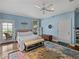 Light and bright primary bedroom features hardwood floors and access to outdoor living at 184 Melissa Trl, Auburndale, FL 33823