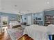Spacious main bedroom featuring hardwood floors, large windows, and a second queen sized bed at 184 Melissa Trl, Auburndale, FL 33823