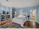 A second view of the main bedroom, with hardwood floors, vibrant wall color and ensuite bathroom at 184 Melissa Trl, Auburndale, FL 33823