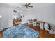 Inviting home office featuring hardwood floors, a ceiling fan, and adjacent exercise room at 184 Melissa Trl, Auburndale, FL 33823