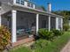 Exterior view of a screened-in porch, showing brick flooring and the seating area at 184 Melissa Trl, Auburndale, FL 33823