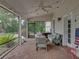 Cozy screened-in porch with brick flooring, comfortable seating, and a view of the backyard at 184 Melissa Trl, Auburndale, FL 33823