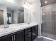 Modern bathroom with double sinks, marble countertop, and glass-enclosed shower at 1851 Daystar Dr, Haines City, FL 33844