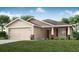 Charming single-story home featuring a two-car garage and well-maintained lawn at 1851 Daystar Dr, Haines City, FL 33844