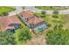 Aerial view of a home with a screened-in pool and lush landscaping at 1902 Altavista Cir, Lakeland, FL 33810