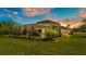 Expansive backyard featuring lush greenery, a screened-in pool area, and a covered outdoor living space at 1902 Altavista Cir, Lakeland, FL 33810