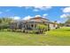 A full view of the backyard showing the patio, pool, and tropical landscaping at 1902 Altavista Cir, Lakeland, FL 33810