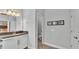Bathroom area features white cabinets and sink with a mirror along with an adjacent water closet at 1902 Altavista Cir, Lakeland, FL 33810