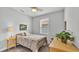 Cozy bedroom with a bed, side table with lamp, a dresser and large window at 1902 Altavista Cir, Lakeland, FL 33810