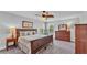 Comfortable bedroom features warm wood furniture, carpet flooring, and a ceiling fan at 1902 Altavista Cir, Lakeland, FL 33810