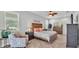 Cozy bedroom with warm lighting, a ceiling fan, and comfortable seating for relaxation and reading at 1902 Altavista Cir, Lakeland, FL 33810