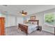 This bedroom has a ceiling fan, a dark wood bed frame, and light grey walls and carpet at 1902 Altavista Cir, Lakeland, FL 33810
