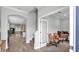 Bright and open foyer leading to living spaces, featuring wood-look tile floors and classic archways at 1902 Altavista Cir, Lakeland, FL 33810