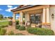Inviting front porch with stone accents and two comfortable wicker chairs overlooking the lush landscaping at 1902 Altavista Cir, Lakeland, FL 33810