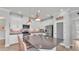 Modern kitchen with stainless steel appliances, white cabinets, and a large center island with barstool seating at 1902 Altavista Cir, Lakeland, FL 33810