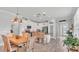 Open-concept kitchen with stainless appliances, white cabinetry, a dining area and pendant lighting at 1902 Altavista Cir, Lakeland, FL 33810