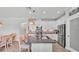 Bright kitchen with white cabinetry, stainless steel appliances, and a large island with seating, perfect for casual dining at 1902 Altavista Cir, Lakeland, FL 33810