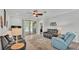 Comfortable living room with stylish furniture, wood floors, and sliding glass doors leading to an outdoor area at 1902 Altavista Cir, Lakeland, FL 33810