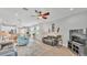 Open-concept living room with hardwood floors, comfortable seating, and seamless transition to the dining area and kitchen at 1902 Altavista Cir, Lakeland, FL 33810
