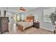 Bright main bedroom with decorative bed, ceiling fan and sliding glass doors to screened patio at 1902 Altavista Cir, Lakeland, FL 33810