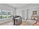 Well-lit home office with a large window, stylish desk, and elegant French doors with neutral decor at 1902 Altavista Cir, Lakeland, FL 33810