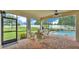 Screened patio boasts brick flooring, ceiling fan, and comfortable wicker seating at 1902 Altavista Cir, Lakeland, FL 33810