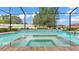 Inviting in-ground pool with a spa and a black mesh screen, perfect for outdoor relaxation and entertaining at 1902 Altavista Cir, Lakeland, FL 33810