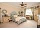 Charming bedroom features a ceiling fan, chair, carpet floors, and natural light from the windows at 1970 Michael Tiago Cir, Maitland, FL 32751