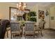 Formal dining room with elegant chairs, a glass-topped table, chandelier and a decorative mirror creating an open feel at 1970 Michael Tiago Cir, Maitland, FL 32751