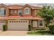 Charming two-story home with a red tile roof, an attached two-car garage, and well-maintained landscaping at 1970 Michael Tiago Cir, Maitland, FL 32751