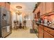 Bright kitchen with stainless steel appliances, updated cabinetry, breakfast nook with a chandelier, and tile flooring at 1970 Michael Tiago Cir, Maitland, FL 32751