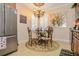 Bright kitchen featuring stainless steel refrigerator, decorative chandelier over breakfast table, and tile flooring at 1970 Michael Tiago Cir, Maitland, FL 32751
